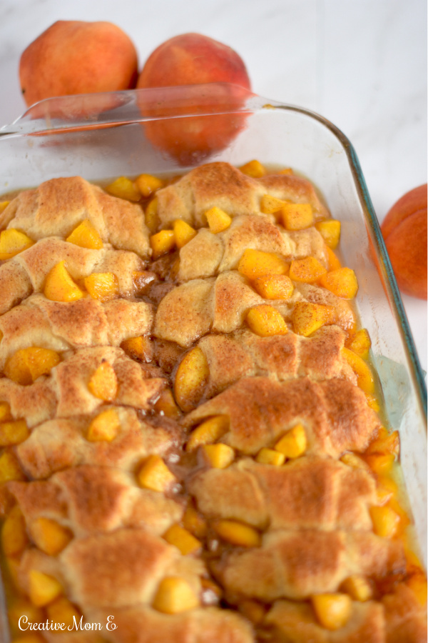 A pan filled with peach cobbler fresh out of the oven.