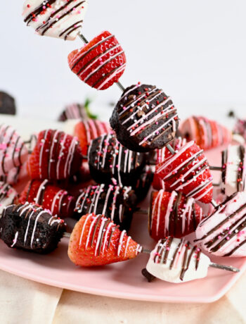 Marshmallow strawberry and brownie on a skewer drizzled with chocolate