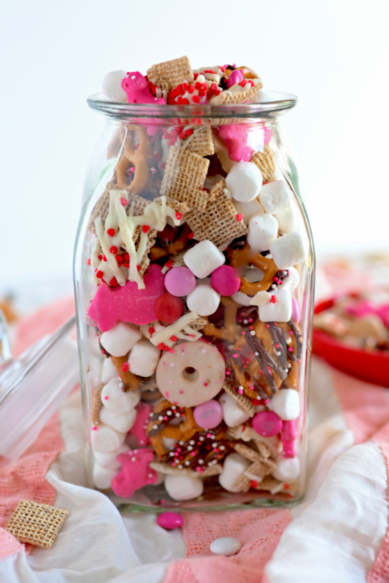 Valentine Chex Mix in a clear jar.