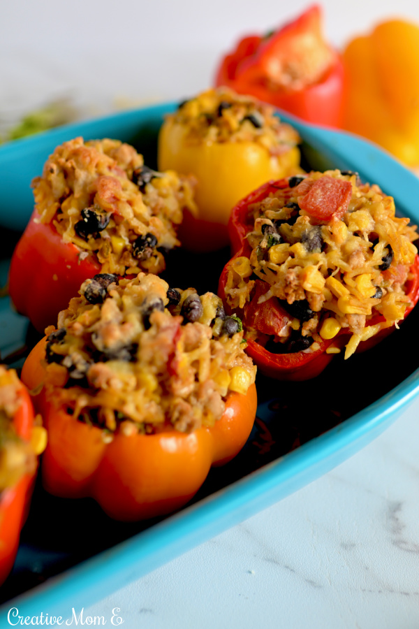Blue baking dish filled with stuffed bell peppers