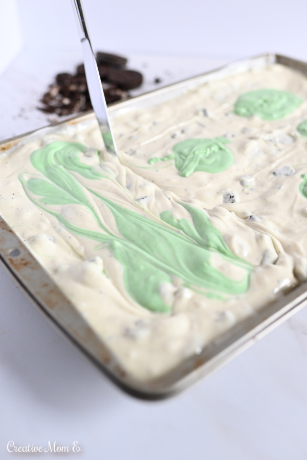 A baking sheet with white and green swirled chocolate