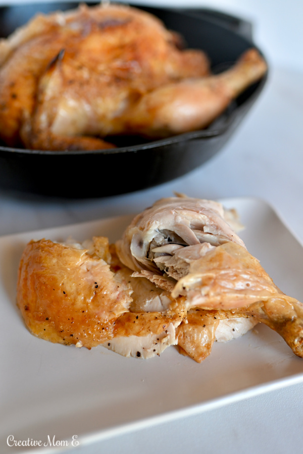 Crispy sliced chicken with chicken leg on a white plate. 