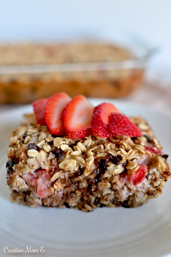 Strawberry Banana Oatmeal Bar on a white plate with a clear dish in the back.