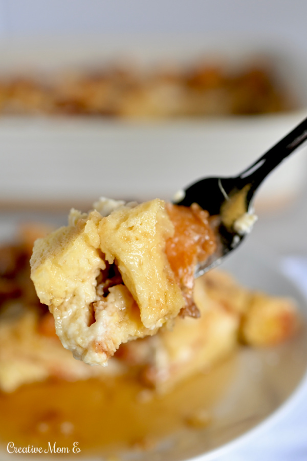 Challah bread French toast casserole bite drenched in maple syrup. 