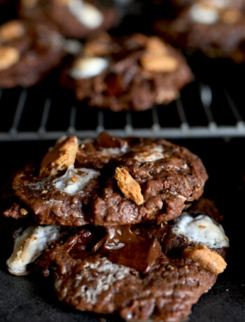 Double Chocolate S'mores Cookies on a cooling rack stacked on each other.