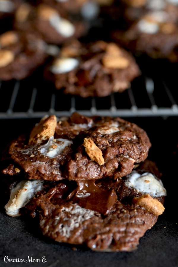 Double Chocolate S'mores Cookies on a cooling rack stacked on each other.