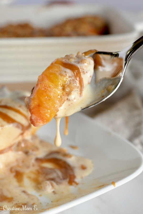 A spoonful of mini peach pies dripping with ice cream and caramel. 