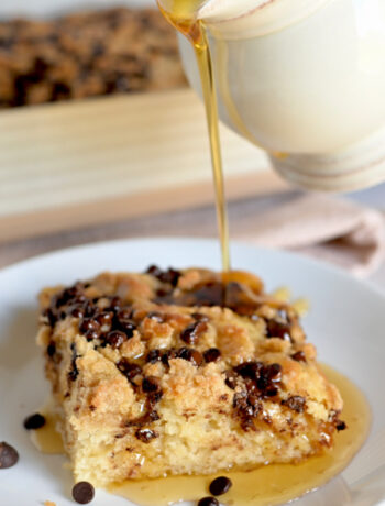 Coffee Cake Pancake on a white plate with maple syrup drizzled over the top.