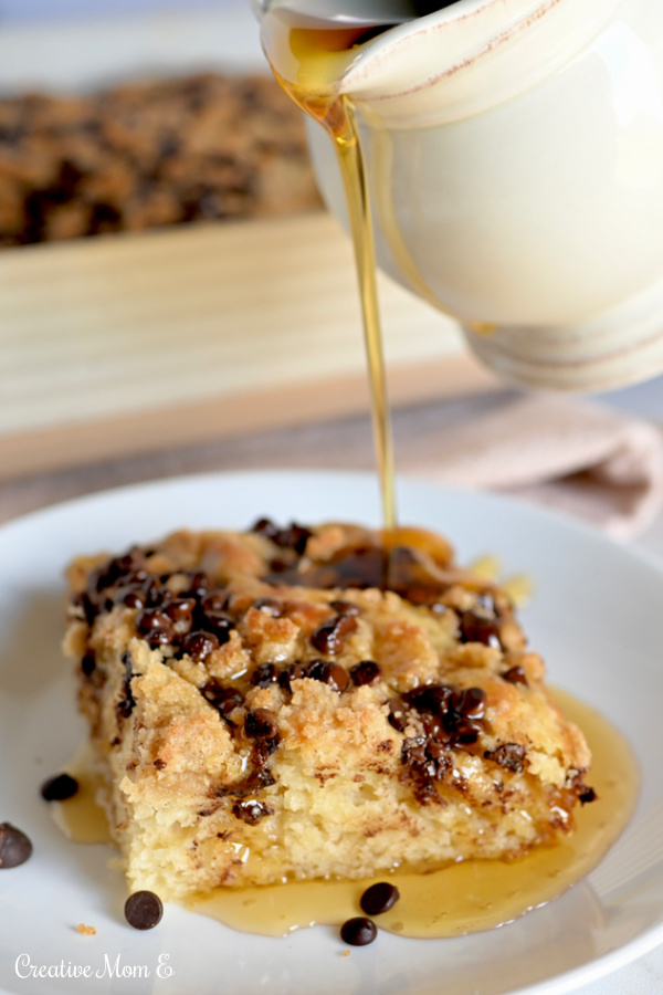 Coffee Cake Pancake on a white plate with maple syrup drizzled over the top.