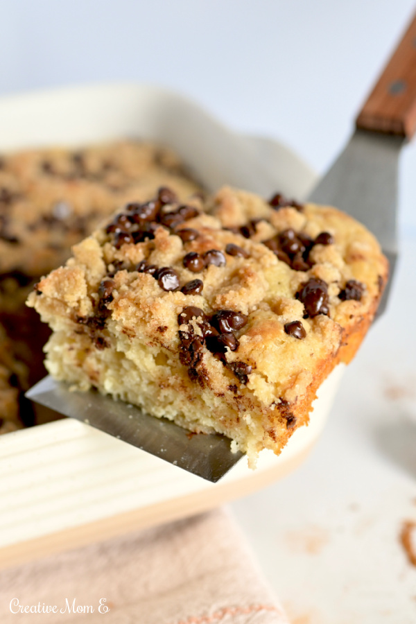 A spatula holding a slice of baked pancake casserole.