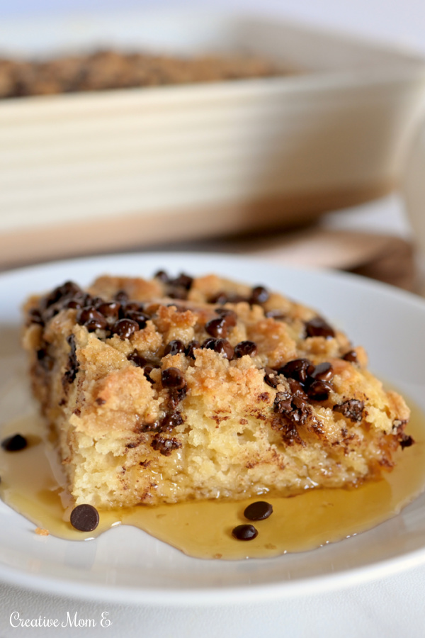 A fluffy slice of pancake coffee cake with a perfect crumble topping drizzled with maple syrup. 